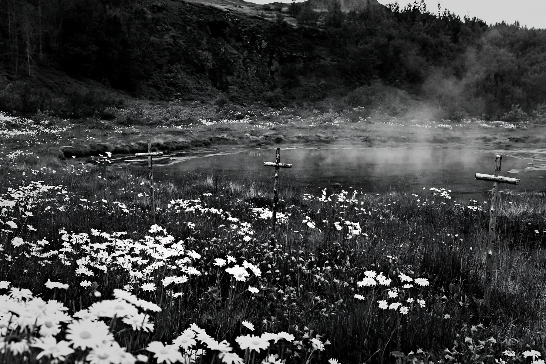 Christian crosses surrounded by flowers near geothermal spring - AI-generated stock image