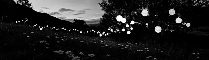 Vibrant Christmas lanterns in meadow at twilight - AI-generated stock image
