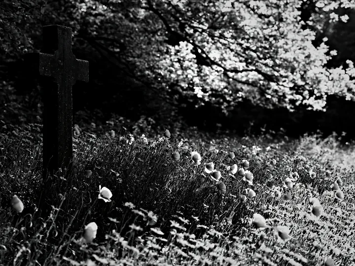 Stone Christian cross in snowy meadow - AI-generated stock image
