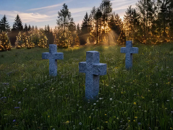 Christian crosses in secluded meadow with sunbeams - AI-generated stock image