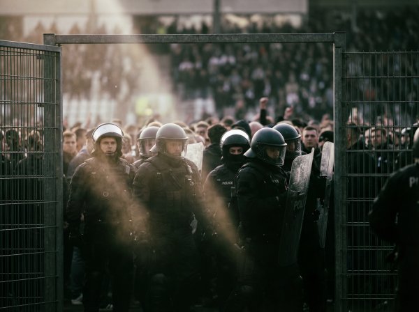 Crowd control at a large event with police presence in the foreground - stock photo