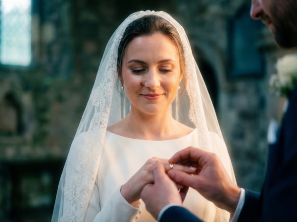 Couple exchanges wedding rings in church during ceremony - stock photo