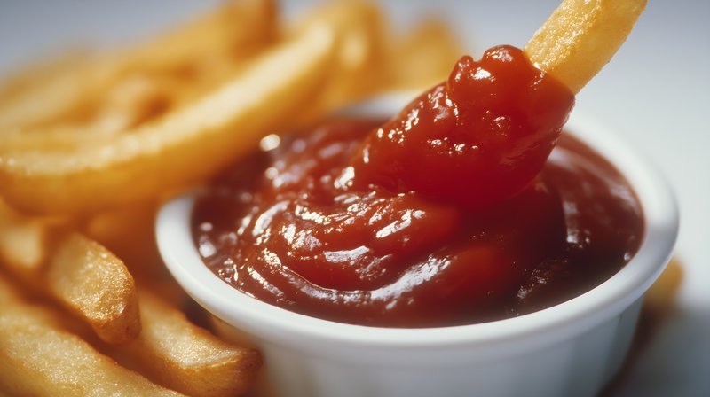 Fries and ketchup on a simple plate in a casual setting Free Premium Stock Photo - stock photo