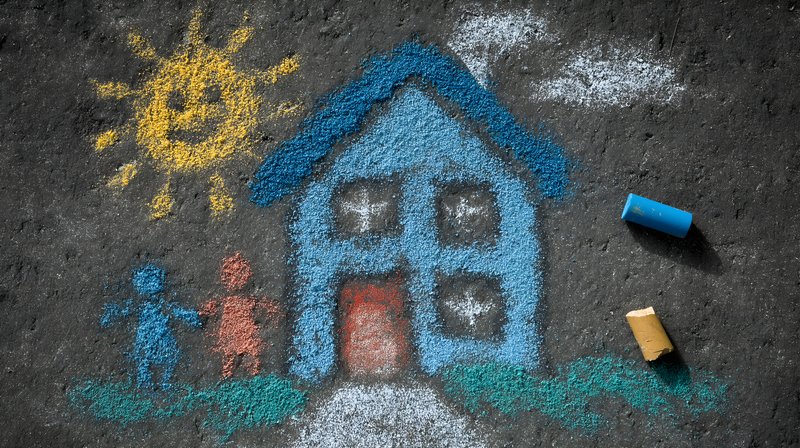 Children draw a house and sun with chalk on the ground Free Premium Stock Photo - stock photo