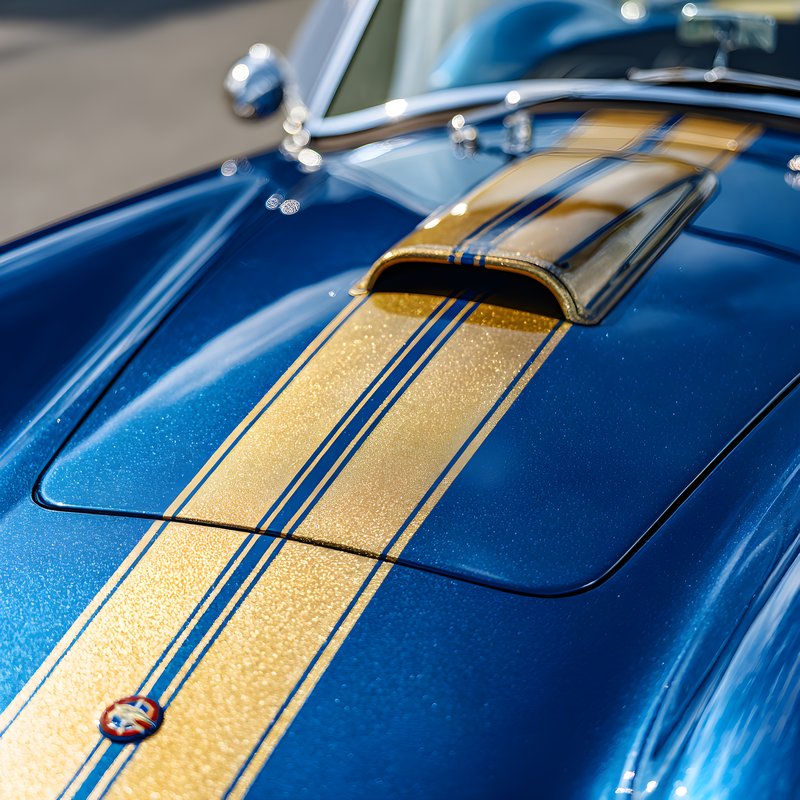 Classic car with blue paint and gold stripes in sunlight Free Premium Stock Image - stock photo