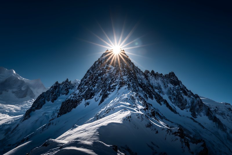 Mountain peak shines under bright sunlight at dawn Free Premium Stock Photo - stock photo