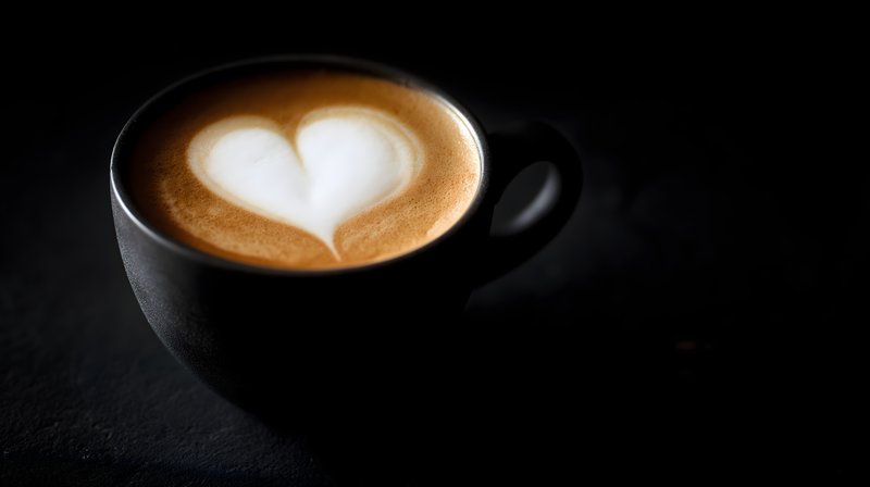 Coffee cup with heart latte art on dark background Free Premium Stock Image - stock photo
