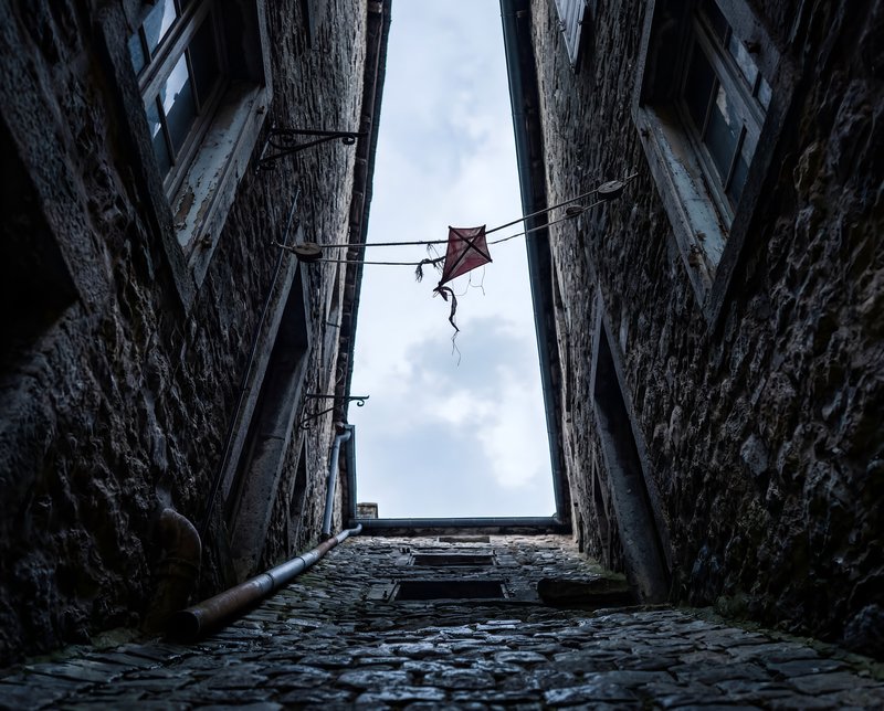 View of a narrow alleyway between old stone buildings Premium Stock Photo - stock photo