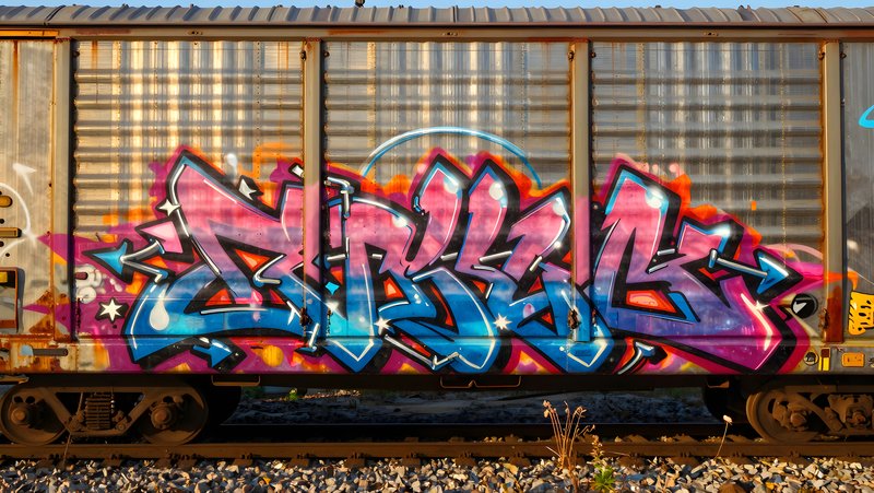 Graffiti art on train car viewed in daylight Premium Stock Image - stock photo