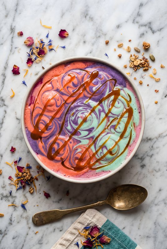 Colorful ice cream in a bowl with toppings on a table Premium Stock Photo - stock photo