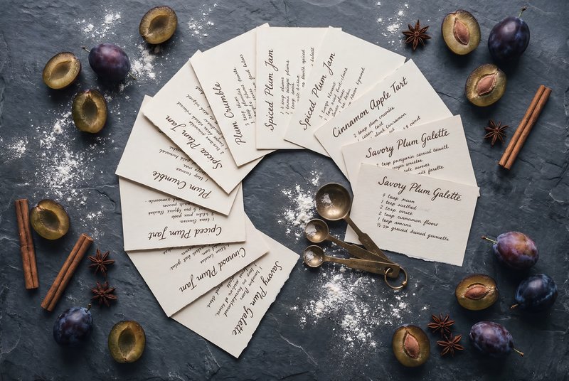 Gathering of recipe cards for plum dessert preparation Premium Stock Photo - stock photo