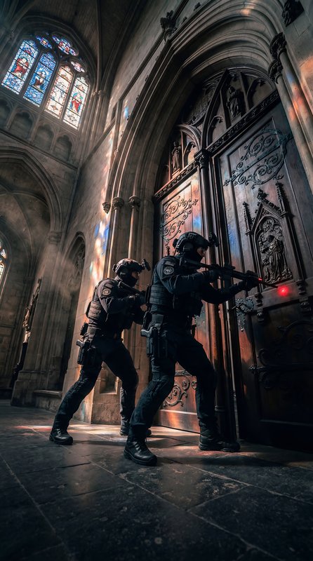 Two officers breach a door inside a historic building Premium Stock Image - stock photo