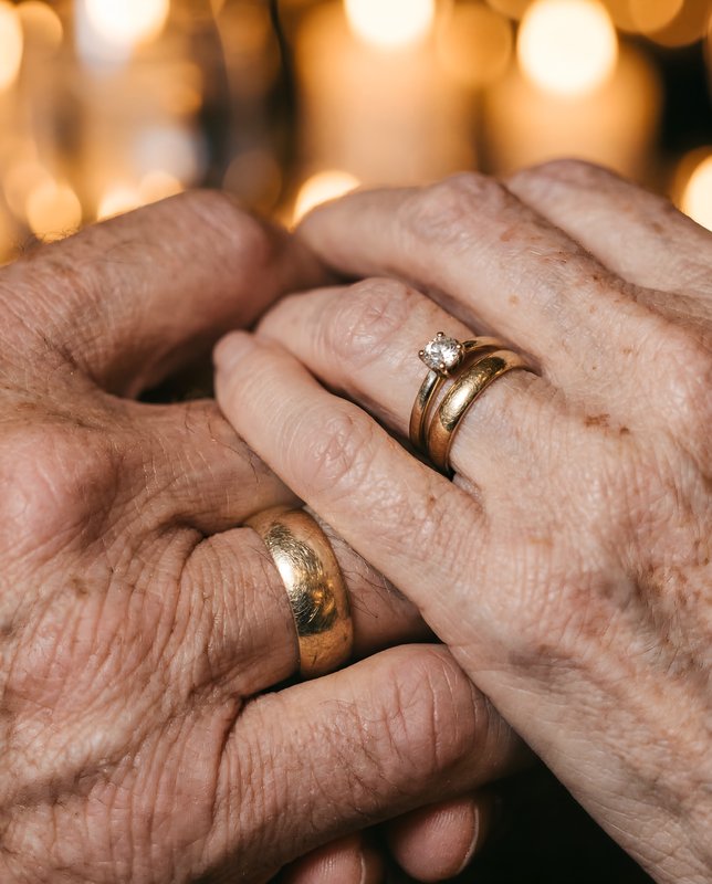 Hands of two people holding each other with wedding rings Premium Stock Photo - stock photo