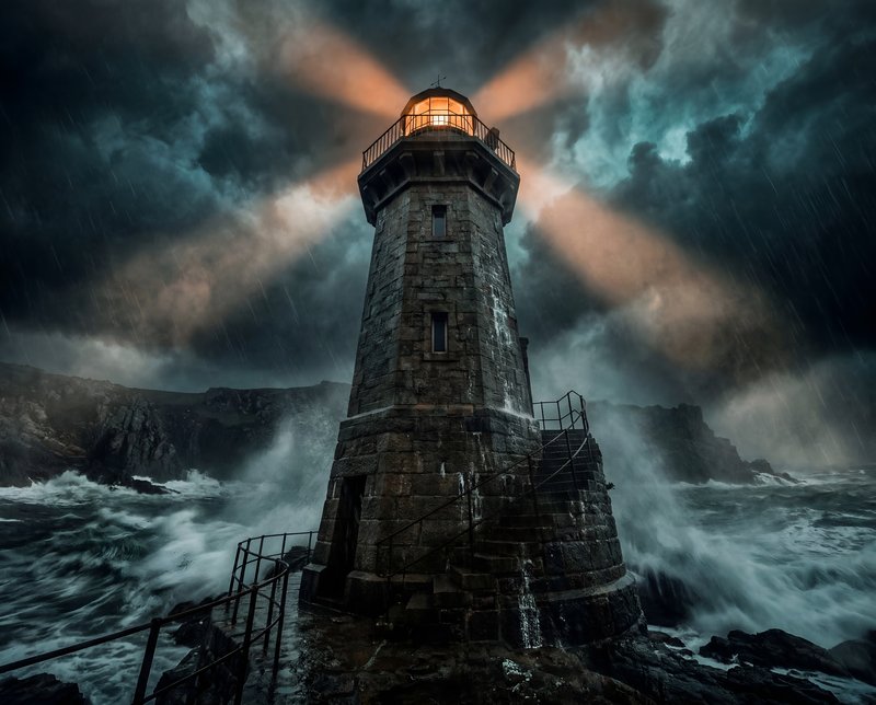 Stormy night at the lighthouse with bright beams of light Premium Stock Image - stock photo