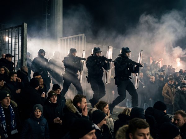 Police officers manage crowd during tense event at sports stadium - stock photo