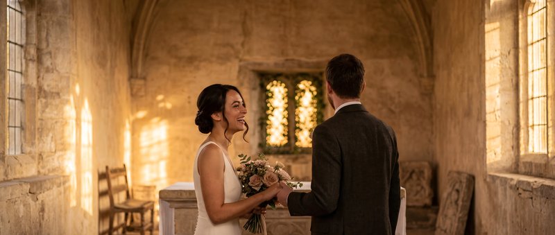 Couple stands together in a historic chapel during sunset Premium Stock Photo - stock photo