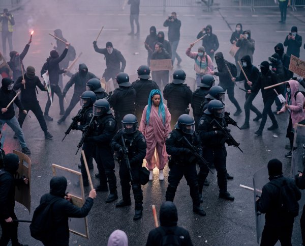 Crowd gathers during protest with police in city center - stock photo