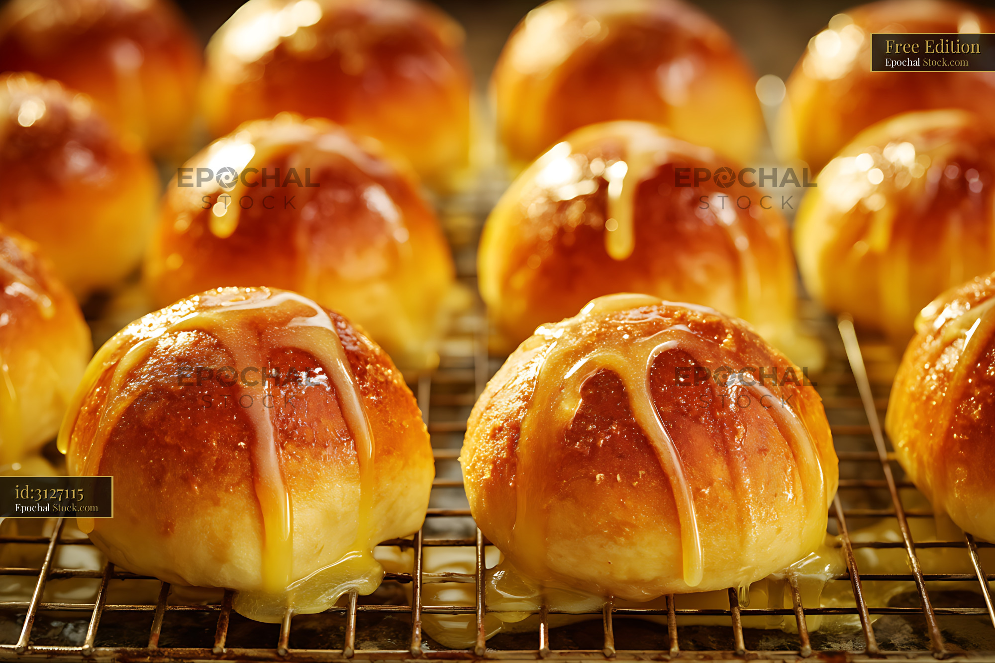 Golden Glazed Pastry Buns on Cooling Rack - stock photo