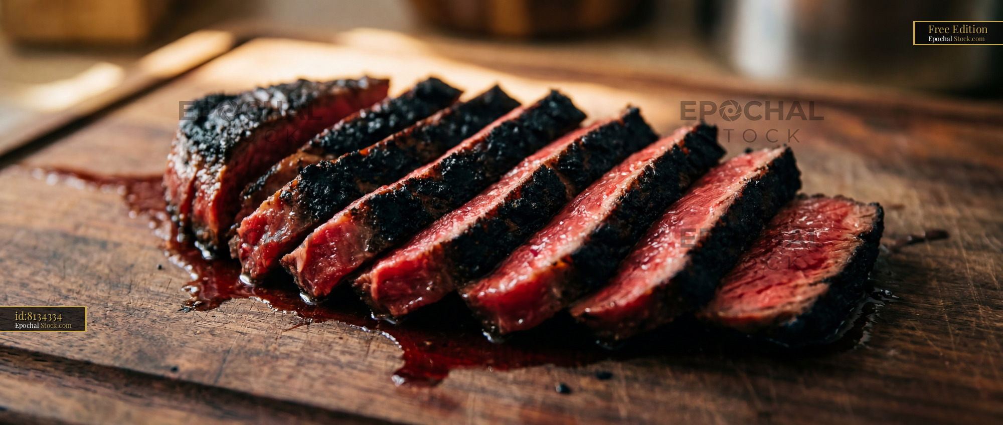 Medium-Rare Steak Slices on Wooden Cutting Board - stock photo