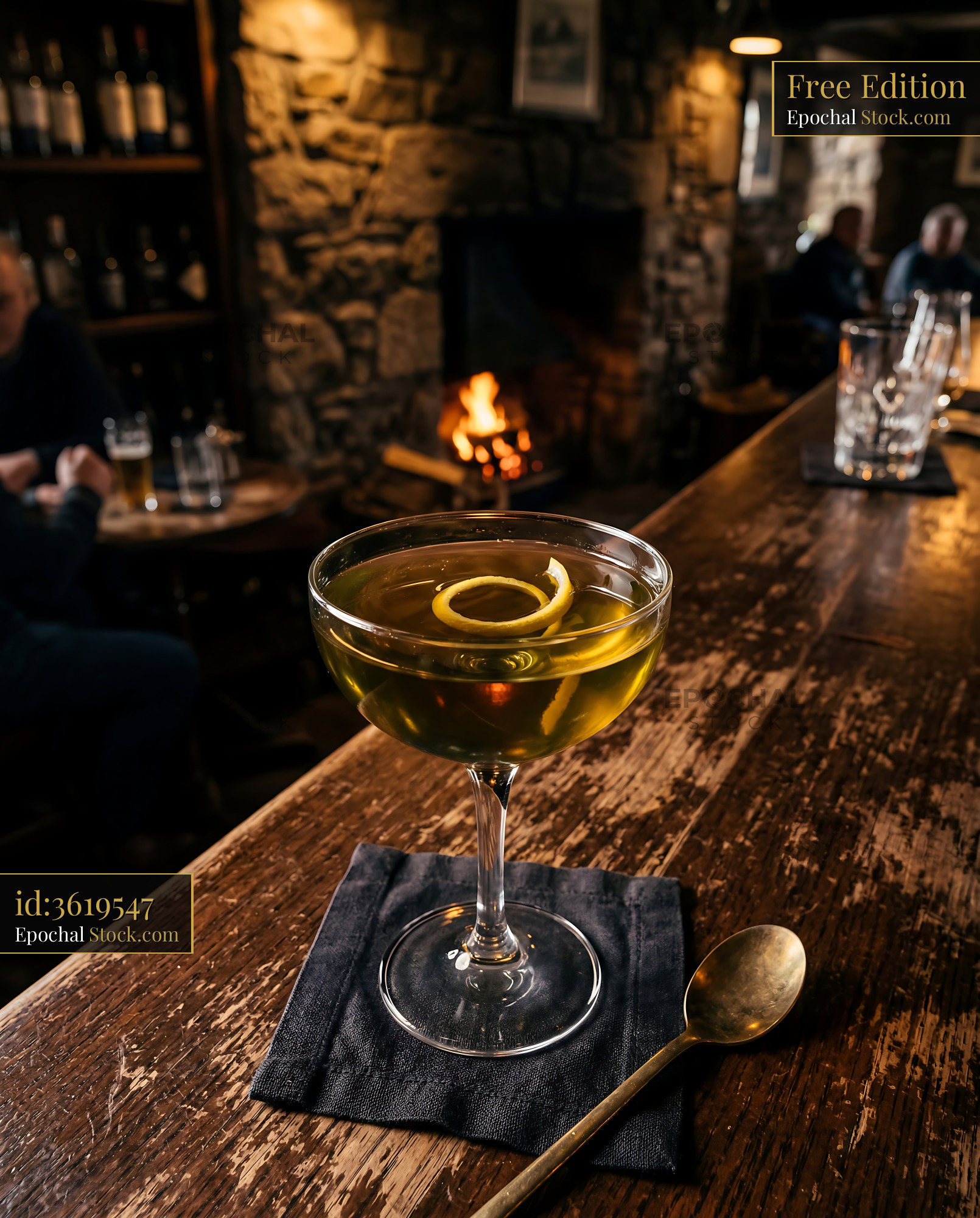 Tipperary Cocktail with Lemon Twist by Fireplace - stock photo