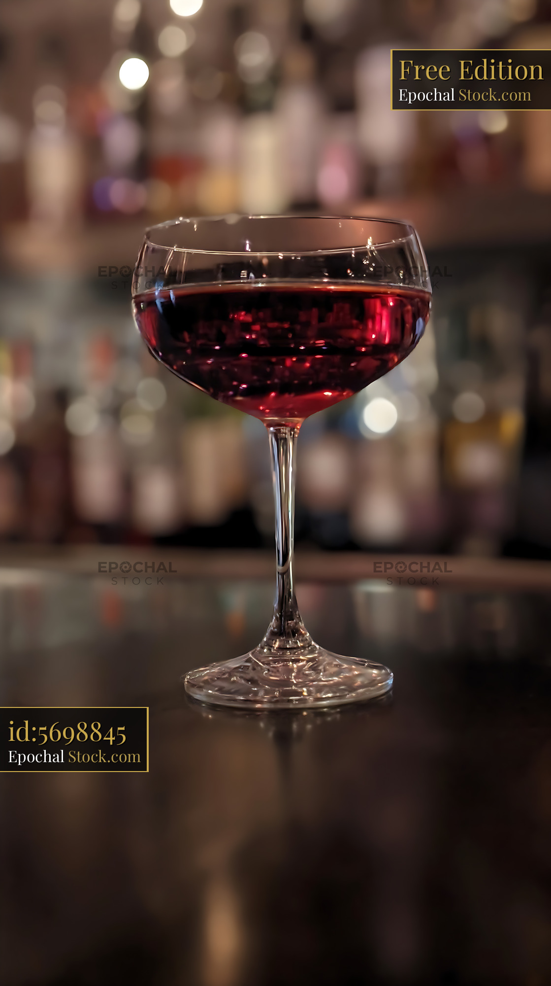 Bushwick Cocktail in Coupe Glass at Bar - stock photo