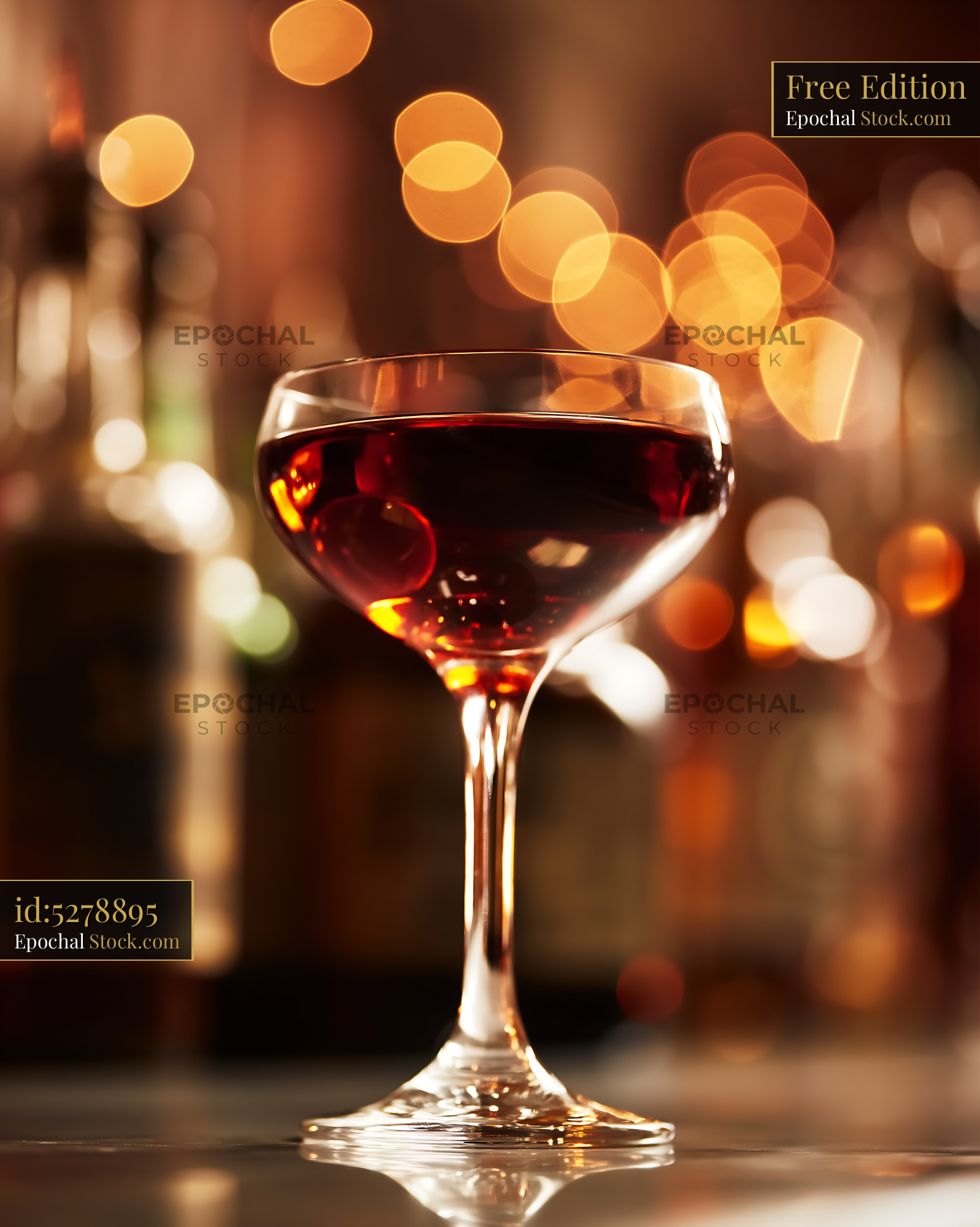 Elegant Red Wine Glass With Warm Bokeh Background - stock photo