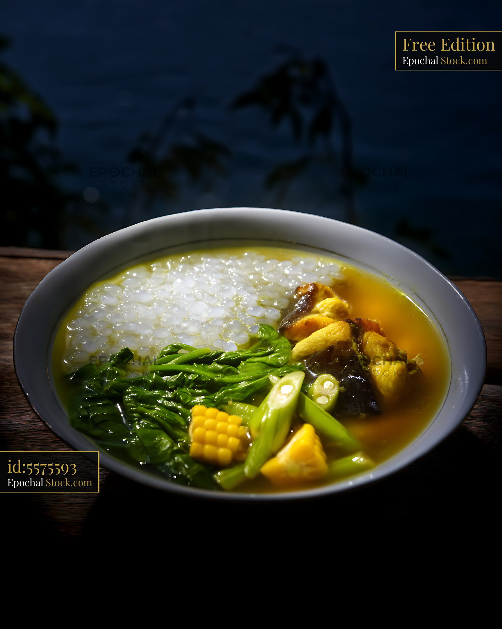 Traditional Kapurung Soup with Fish and Greens at Night - stock photo