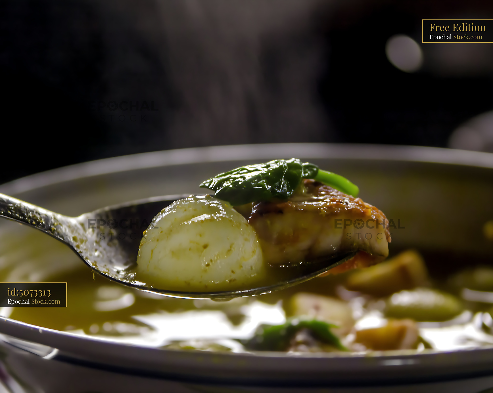 Hot Kapurung Soup with Fish, Sago, and Greens on Spoon - stock photo
