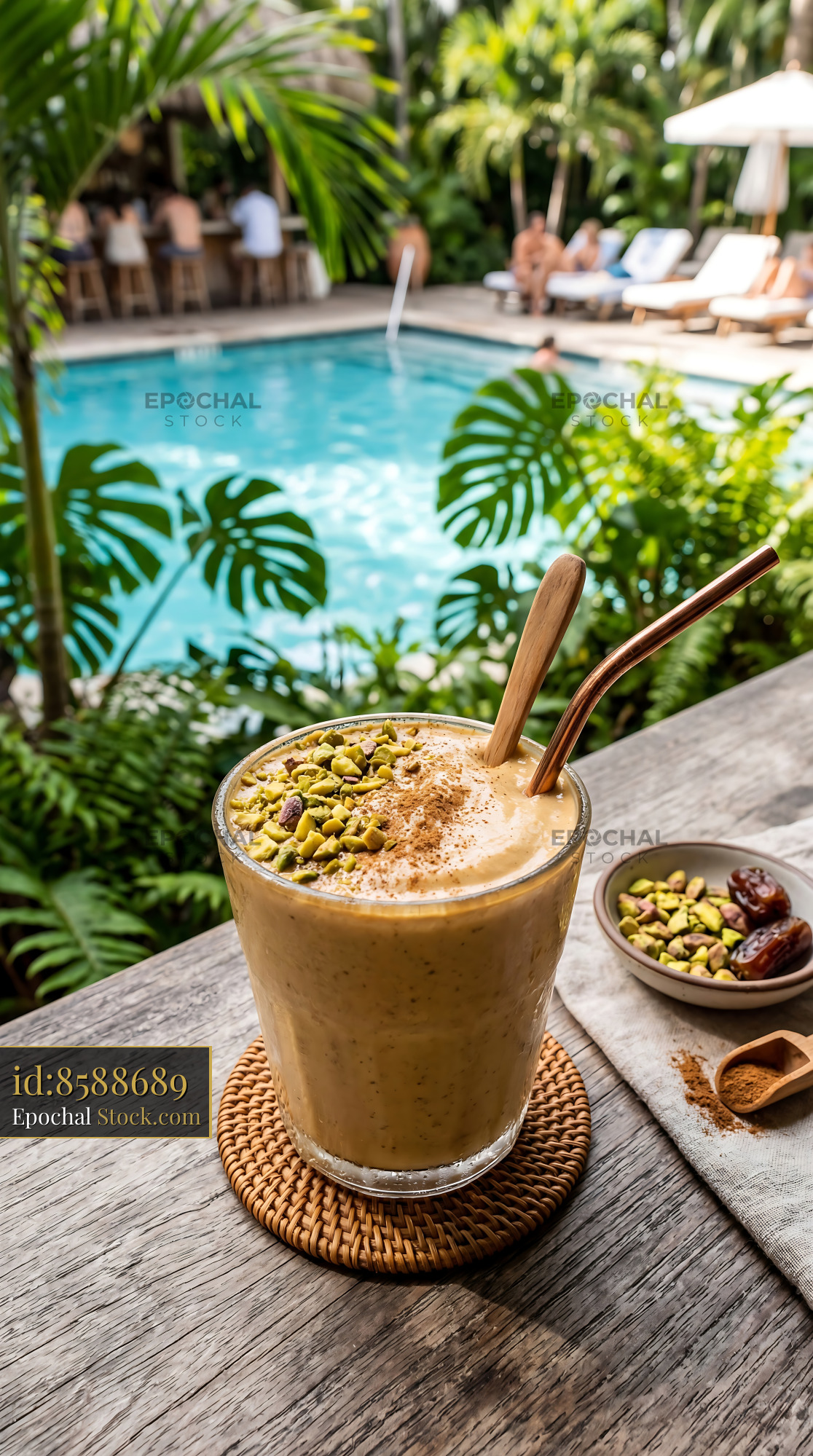 Tahini Date Shake by Pool with Pistachios - stock photo