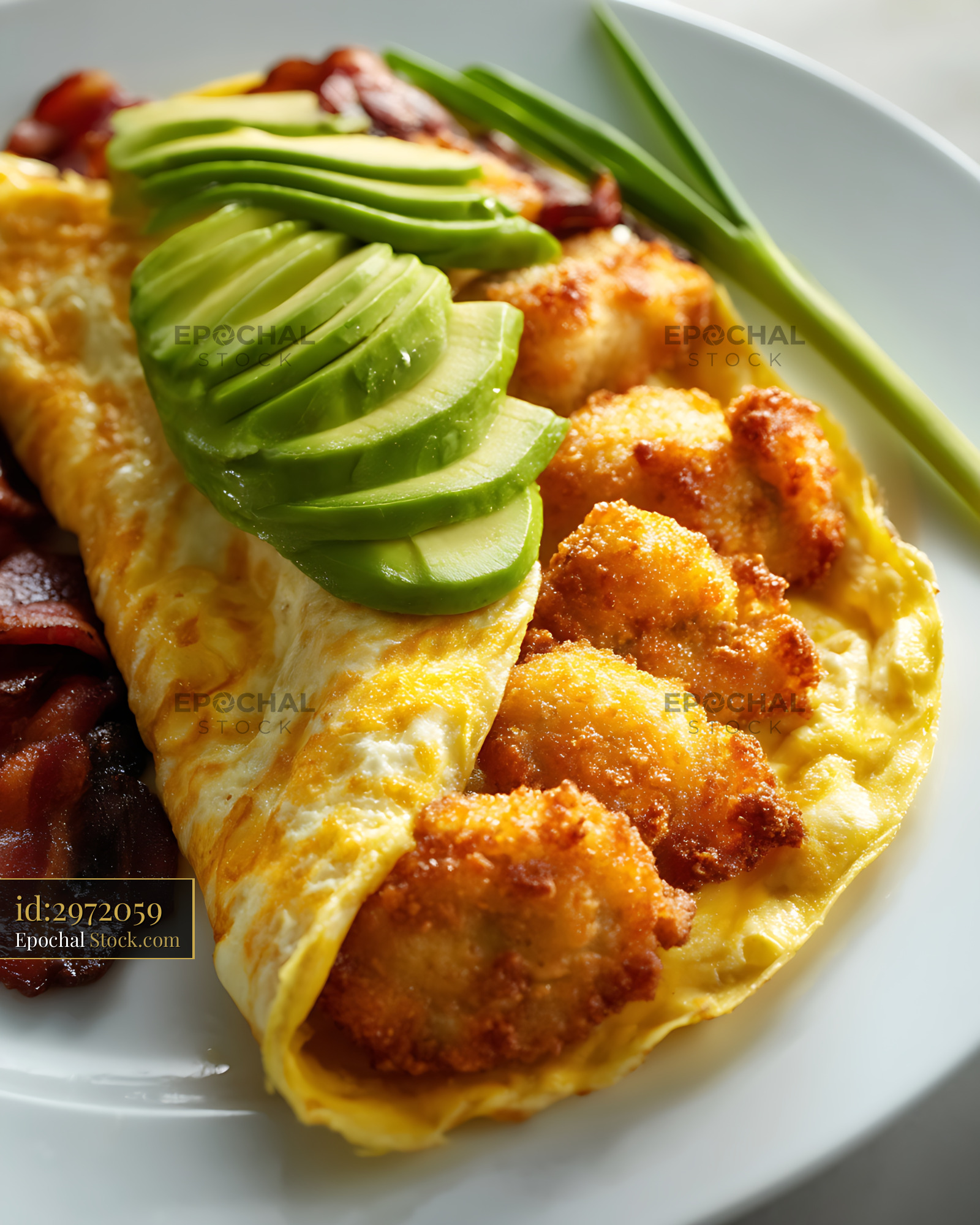 Golden Omelet with Hash Browns and Bacon - stock photo