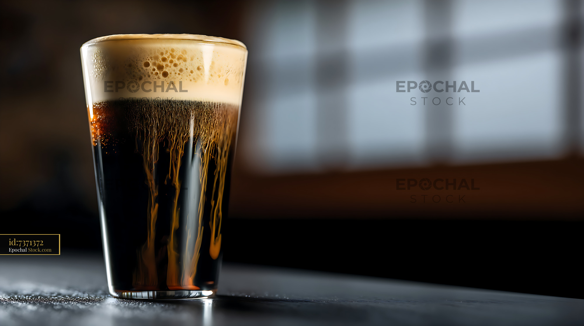 Freshly Poured Pint of Dark Beer with Foam Head - stock photo