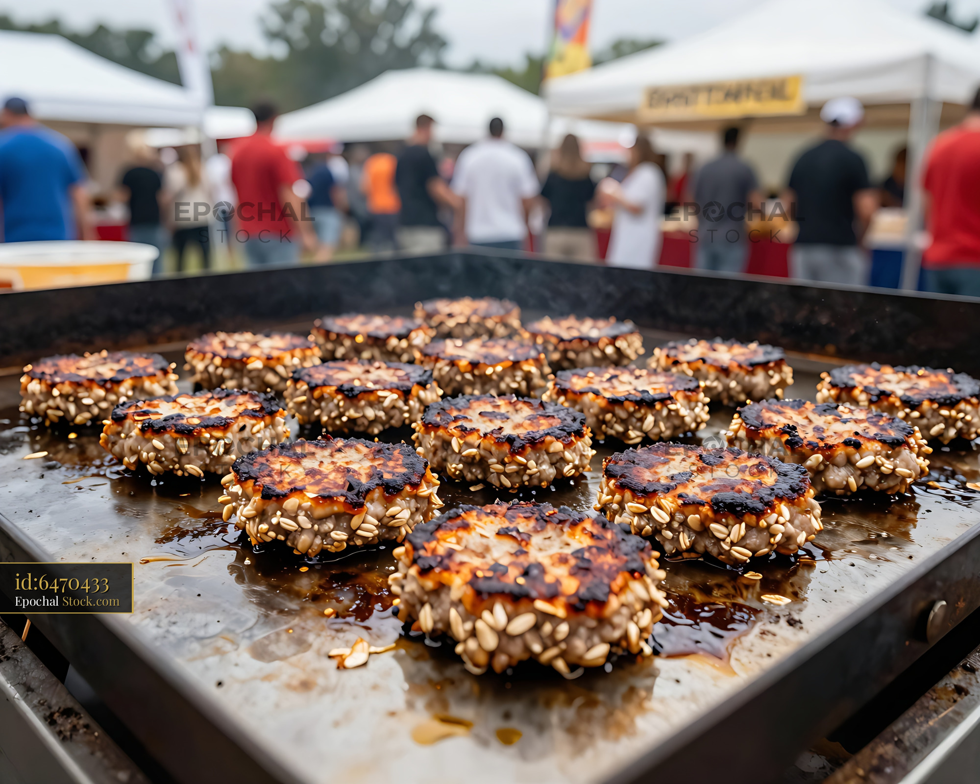 Grilled Sesame Seed Patties at Outdoor Food Event - stock photo