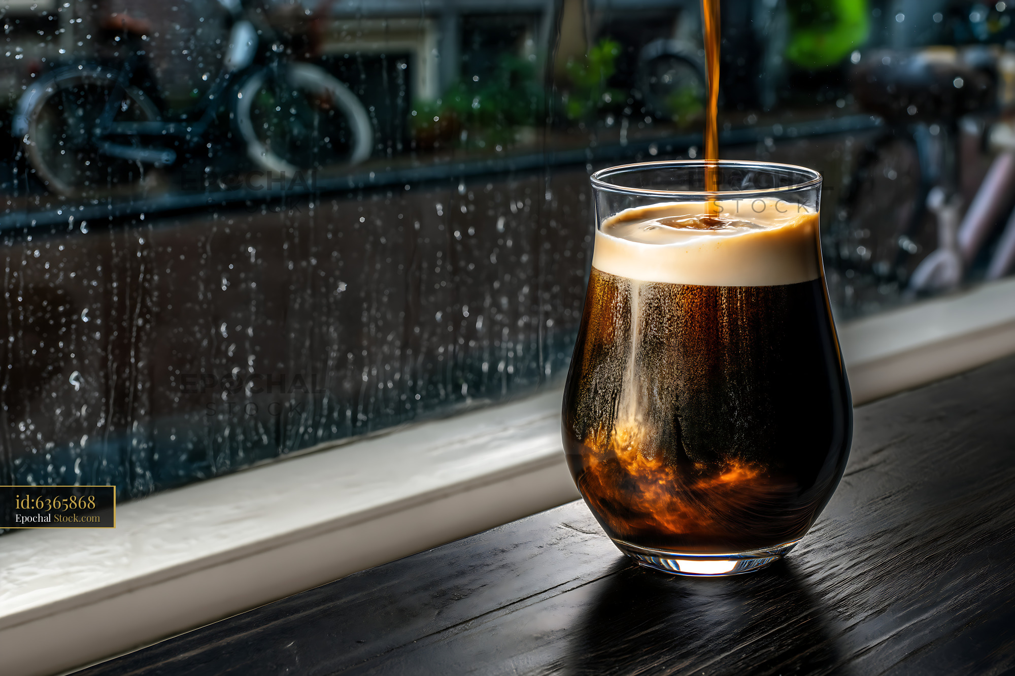 Nitro Caramel Coffee Poured on Rainy Day - stock photo