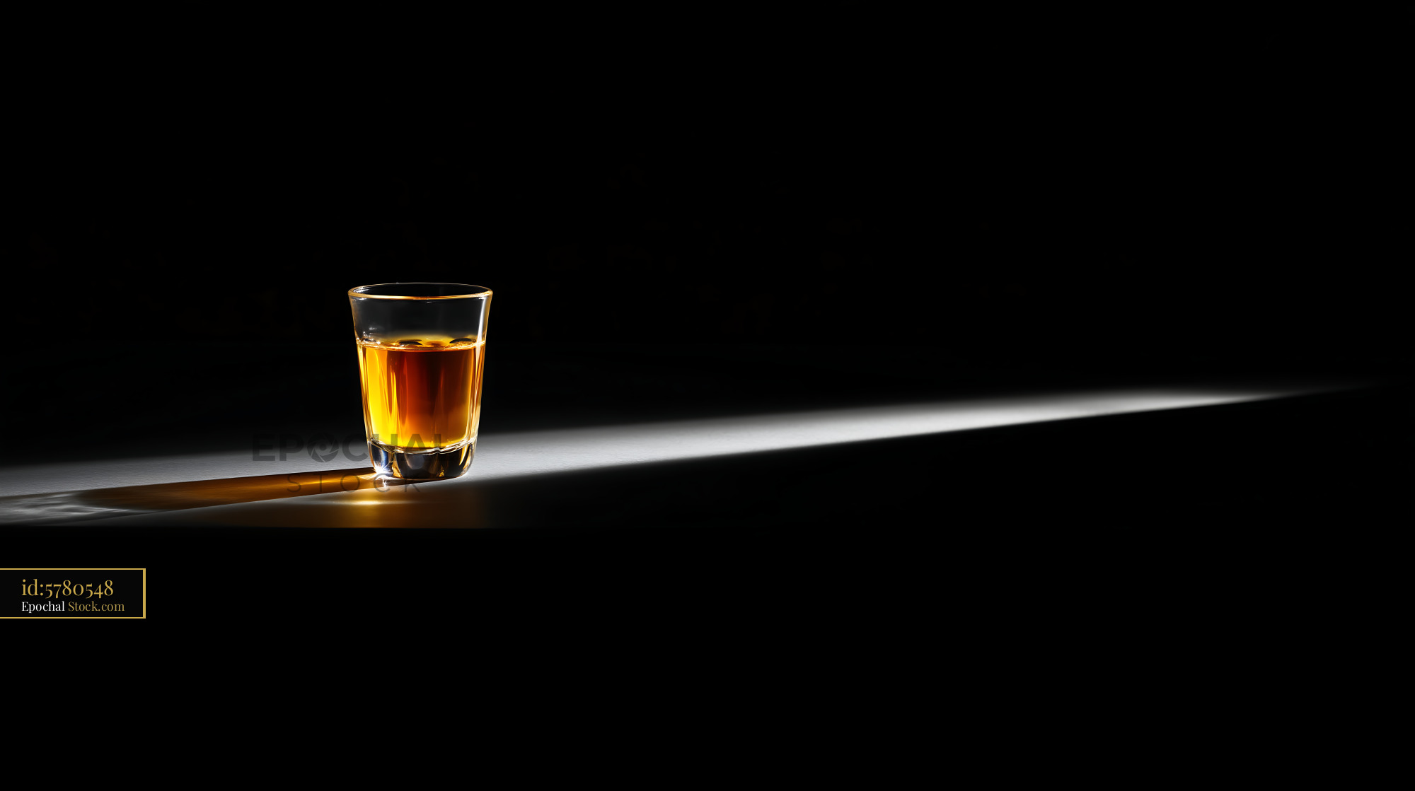Whiskey Glass with Dramatic Side Lighting - stock photo