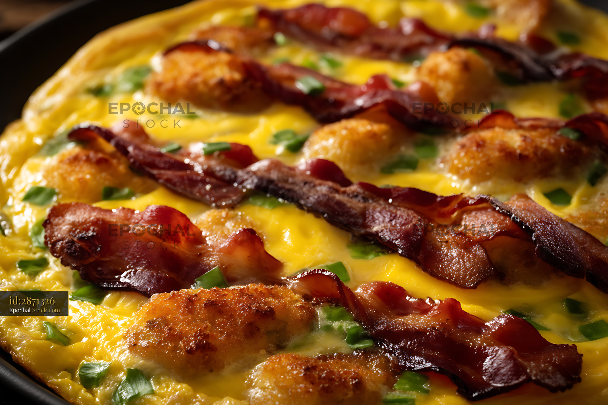 Crispy Bacon Cheddar Omelet in Cast Iron Skillet - stock photo