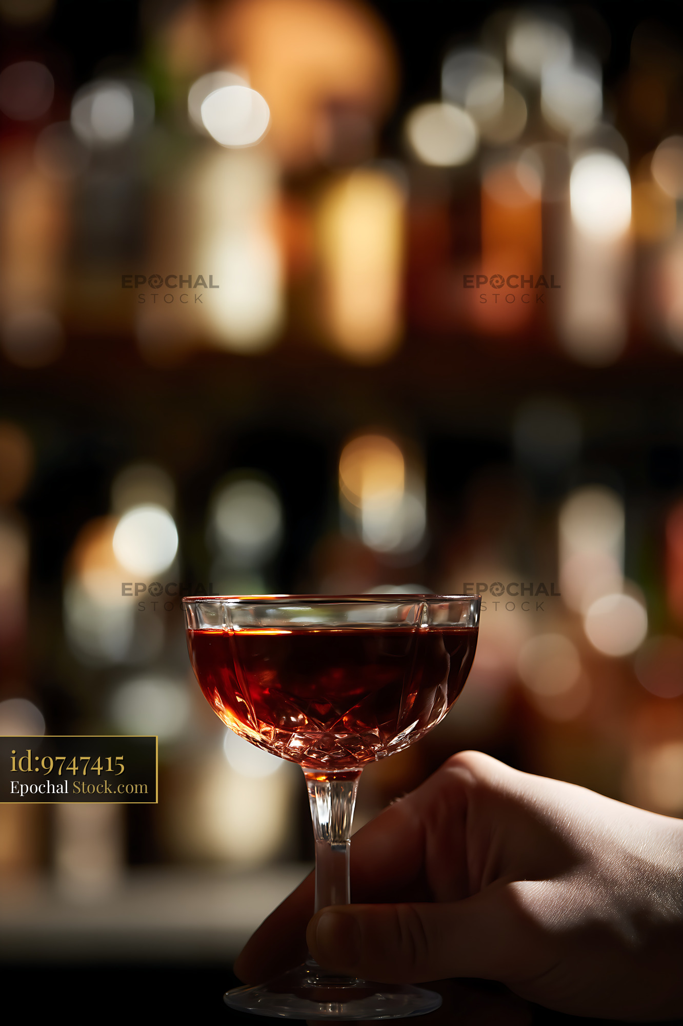 Bushwick Cocktail in Hand Against Bar Lights - stock photo
