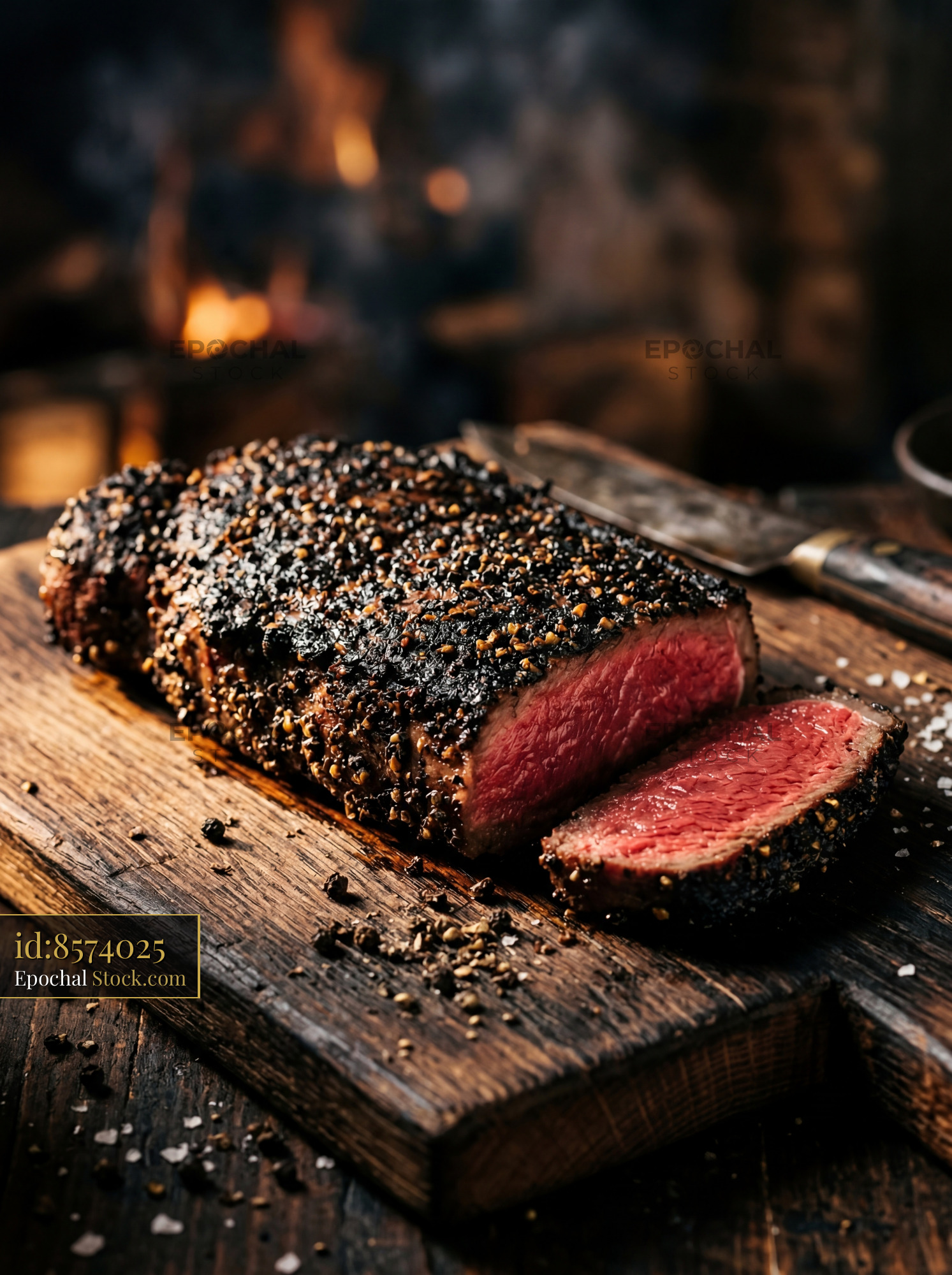 Rare Steak with Peppercorn Crust on Board - stock photo