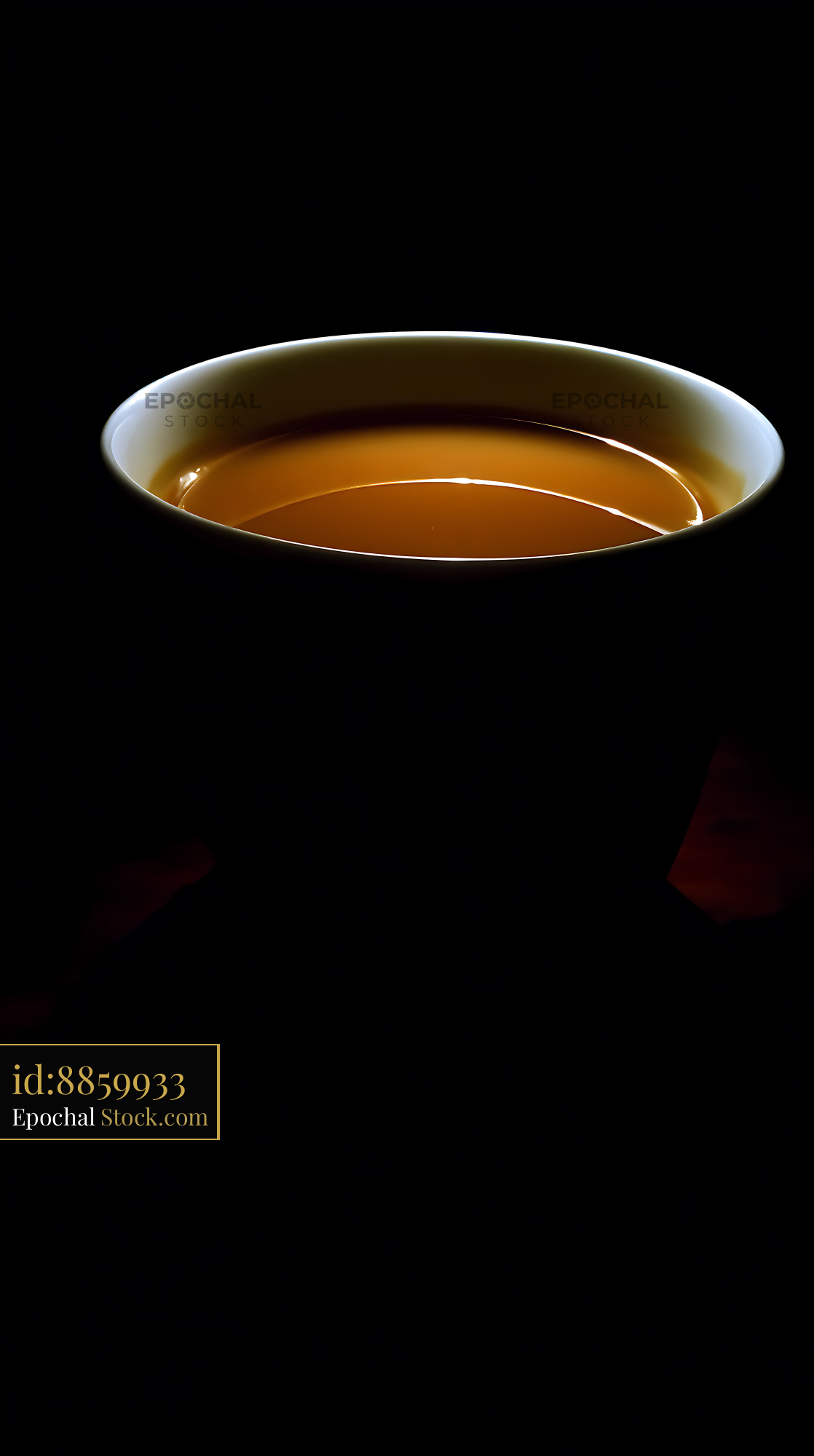 Golden Broth Bowl on Black Background Flat Lay - stock photo
