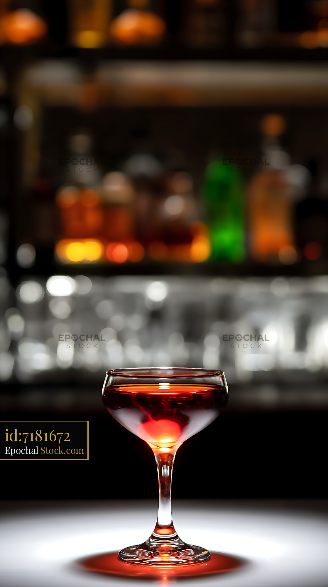 Backlit Red Cocktail with Cherry at Bar - stock photo