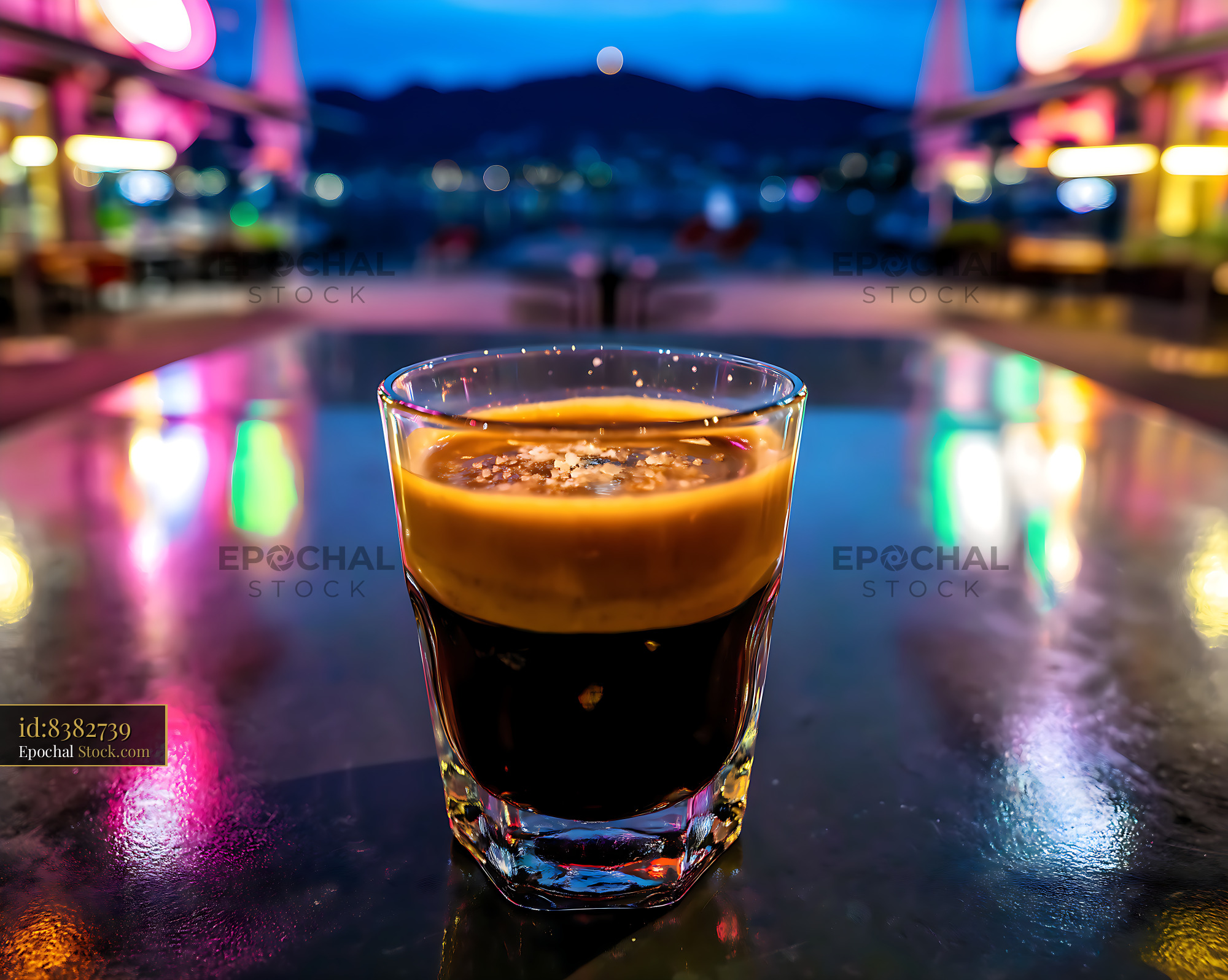 Whiskey Shot Glass at Neon-Lit Bar Counter - stock photo