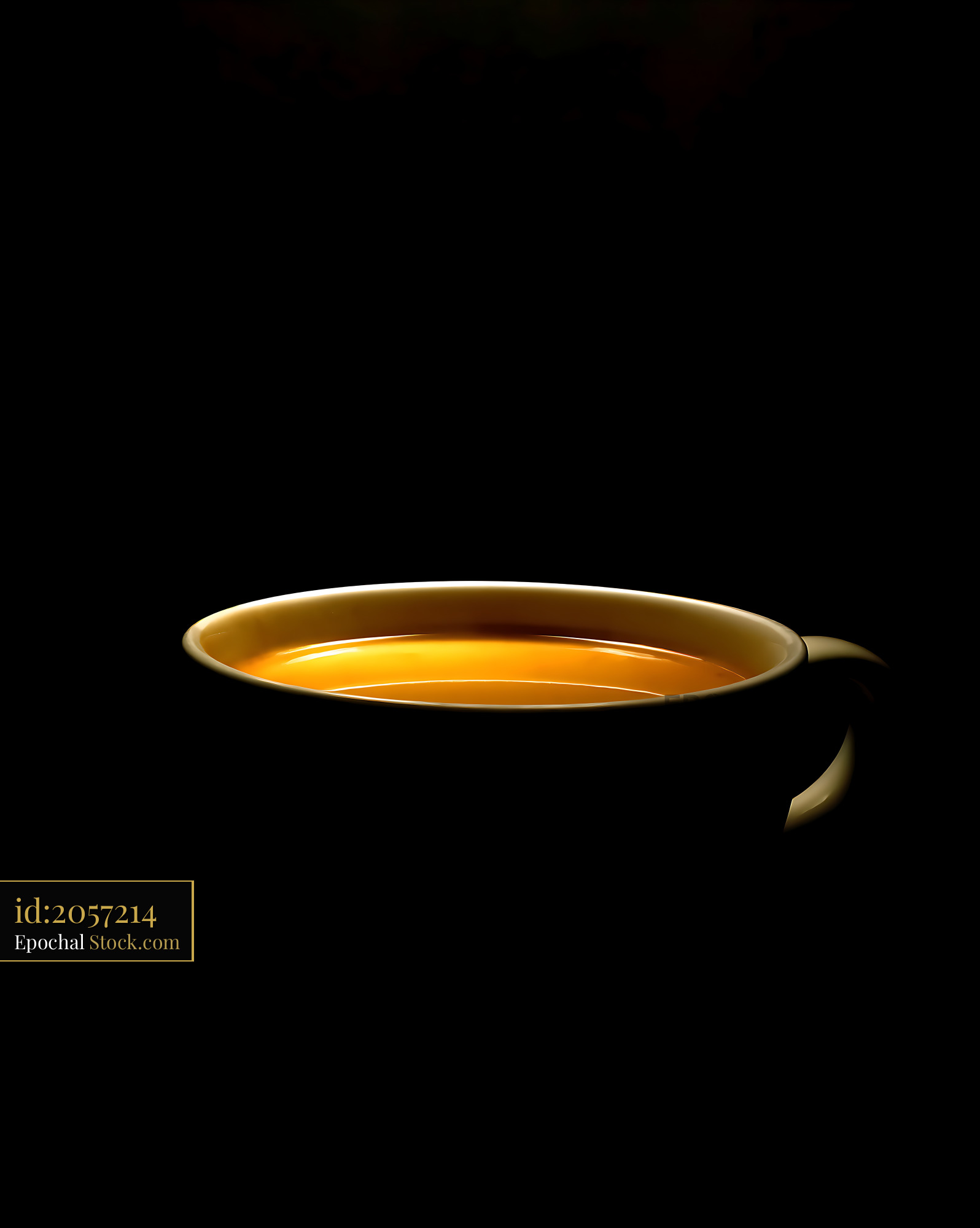 Golden Tea Steaming in Ceramic Mug, Black Backdrop - stock photo