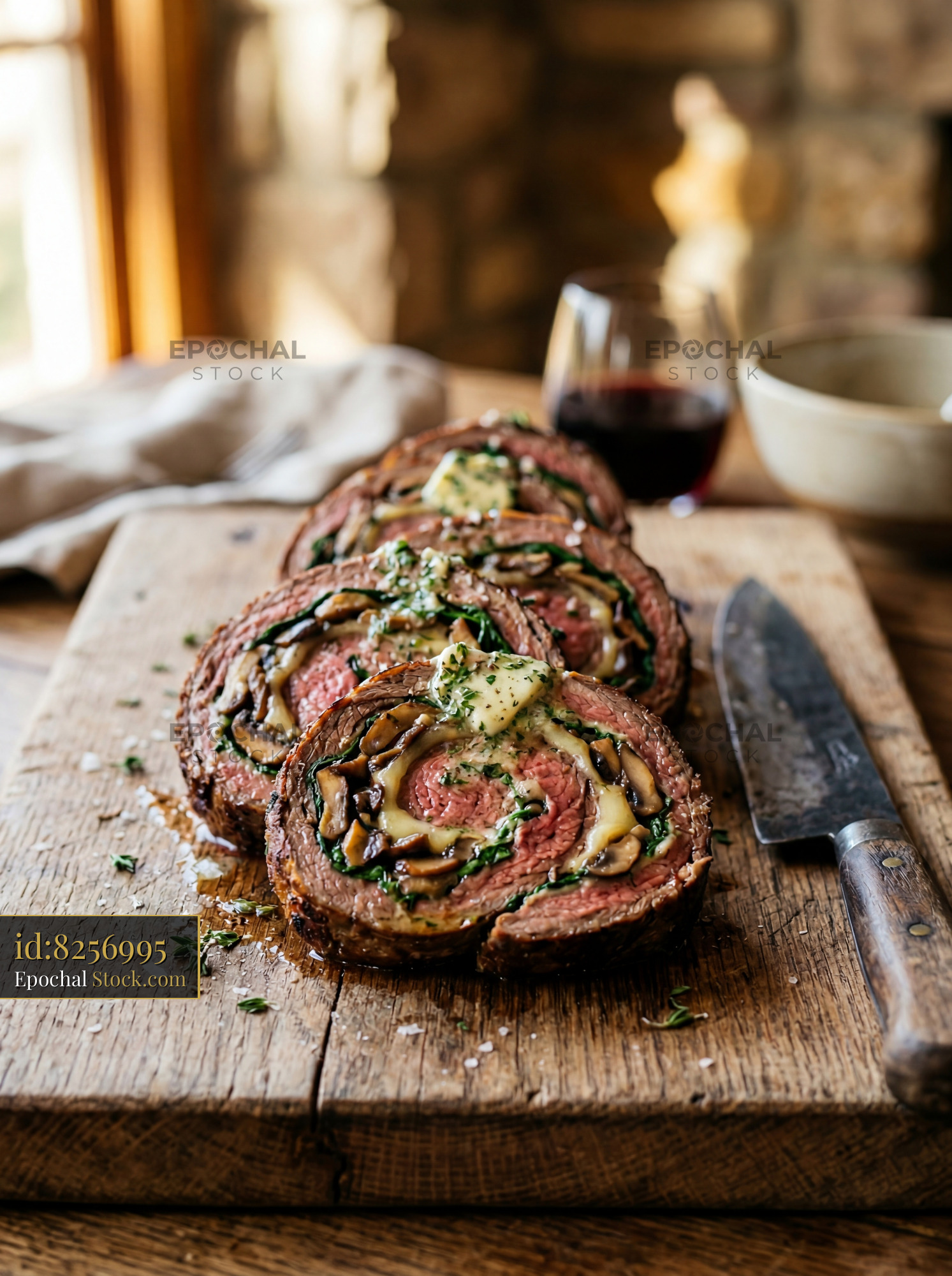 Beef Roulade Sliced on Rustic Wooden Board - stock photo