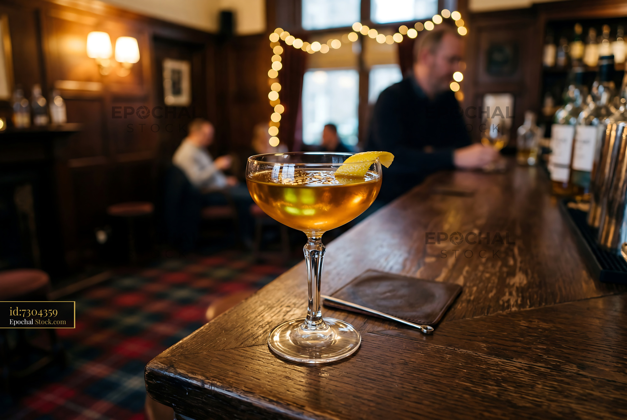 Tipperary Cocktail with Lemon on Bar Counter - stock photo