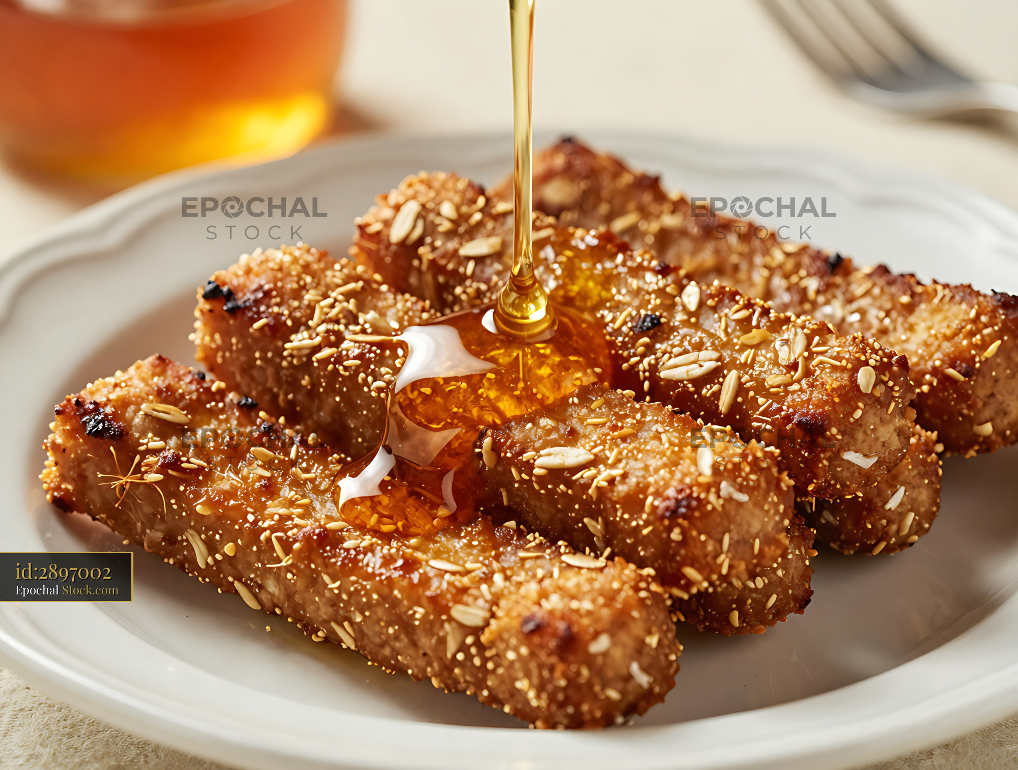 Goetta Slices with Honey Drizzle and Sesame Seeds on White Plate - stock photo