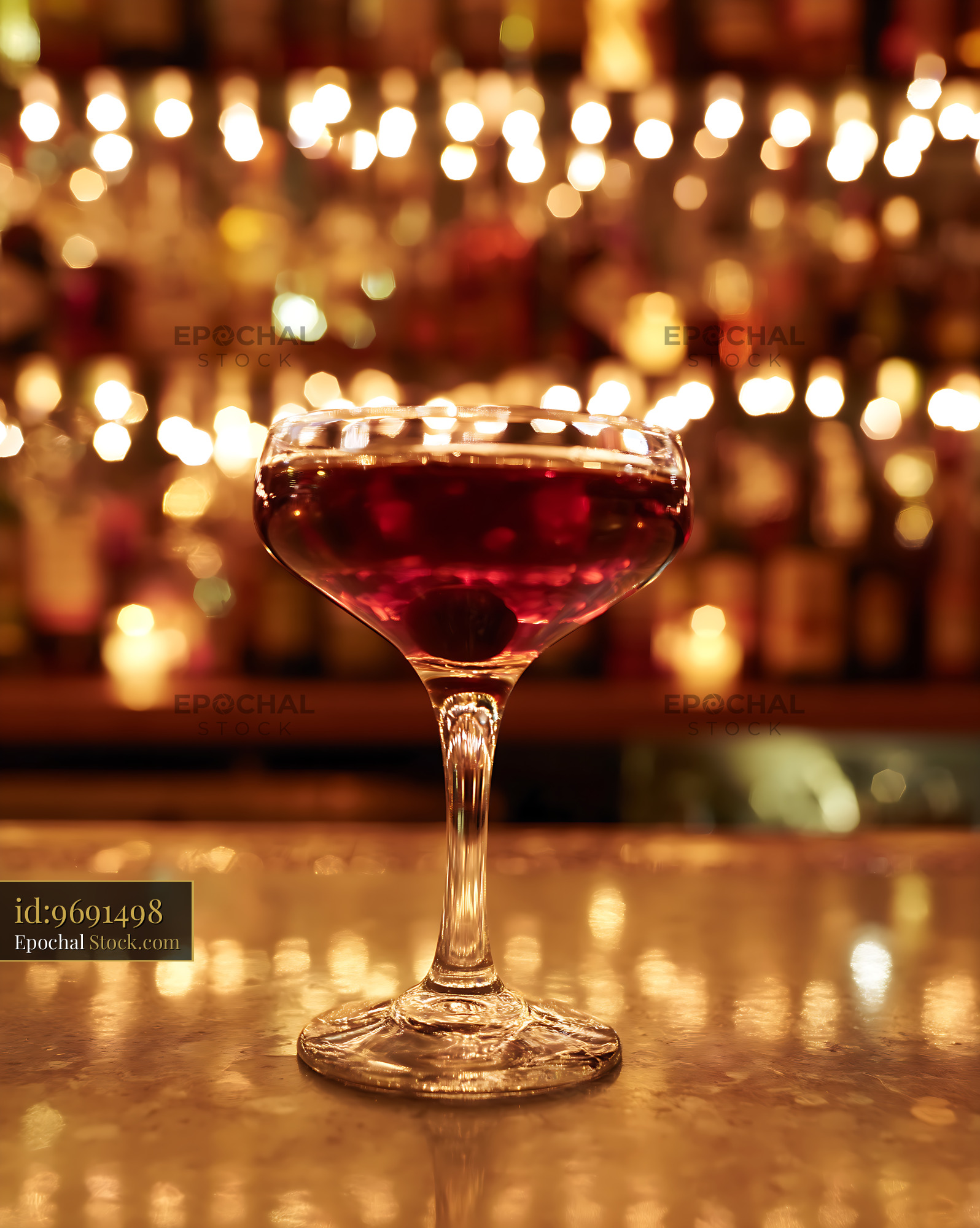 Bushwick Cocktail in Coupe Glass at Bar - stock photo
