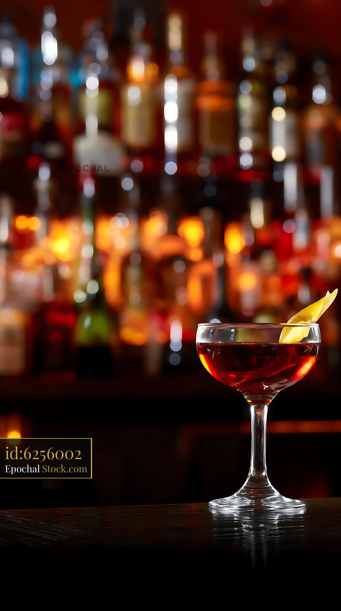 Elegant Red Cocktail with Lemon at Bar Counter - stock photo