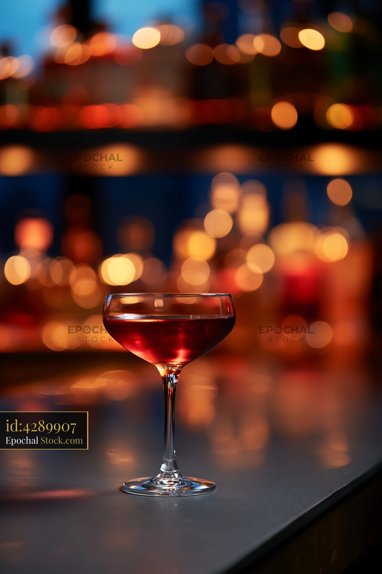 Red Cocktail Coupe Glass with Bokeh Lights - stock photo