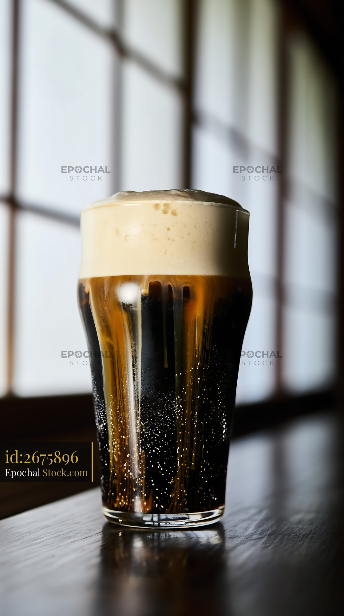 Dark Beer Glass with Creamy Foam Head - stock photo