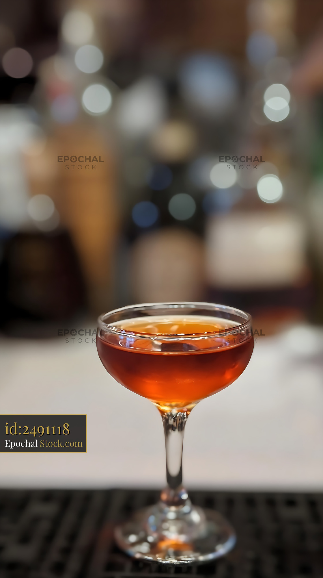 Bushwick Cocktail in Coupe Glass at Bar - stock photo