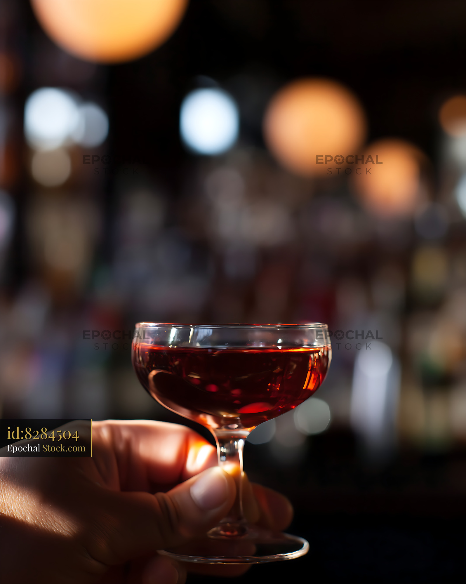 Bushwick Cocktail in Hand Against Lights - stock photo